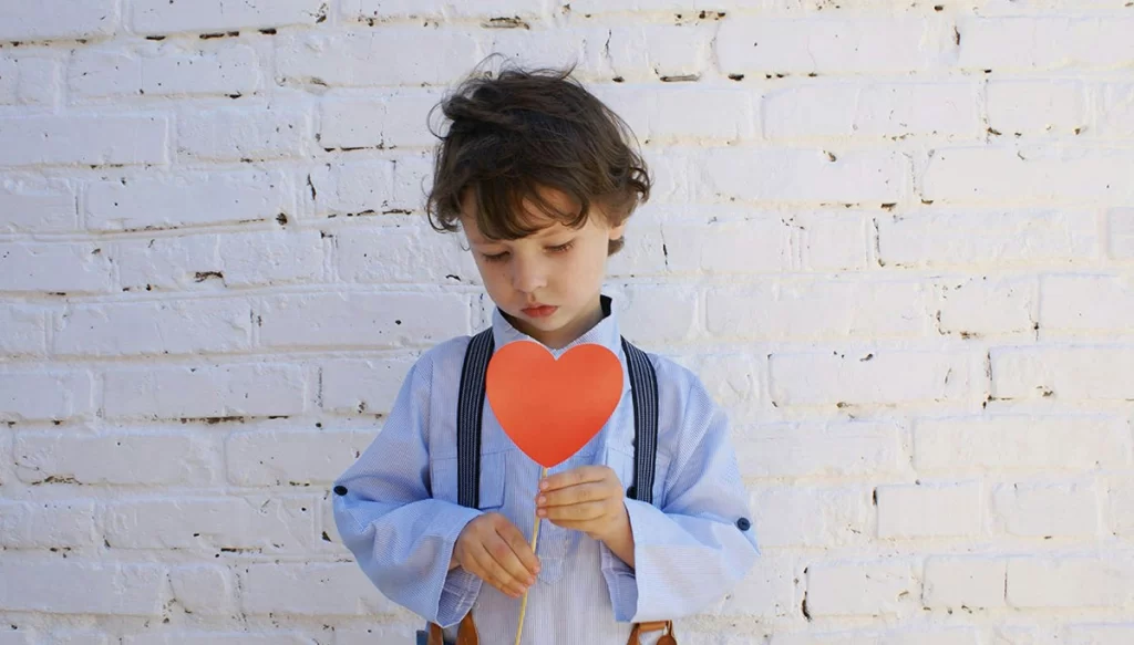 child holding paper heart