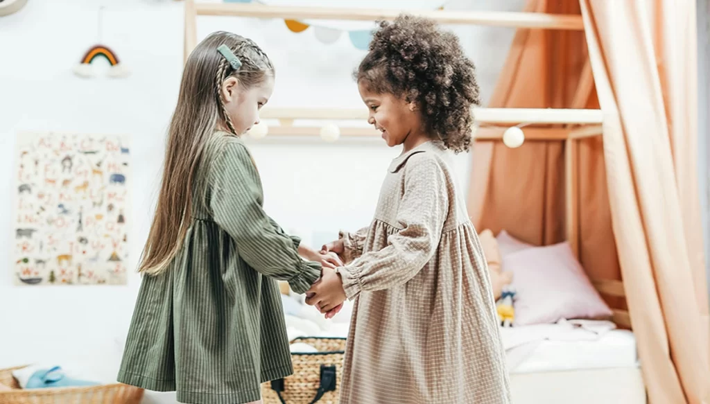 two little girls in dresses communicating